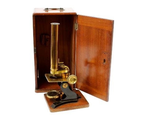 An early 20th century black-painted and lacquered brass monocular microscope, rack and pinion adjustment, convex mirror, 31cm