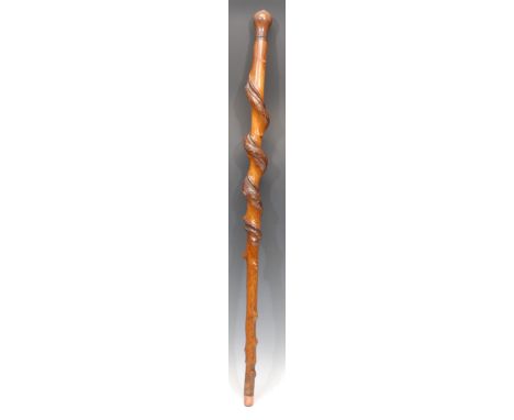 A 19th century twisted hazel walking stick, hardwood knop set with a silver coloured metal armorial roundel, spiral cane, 93c