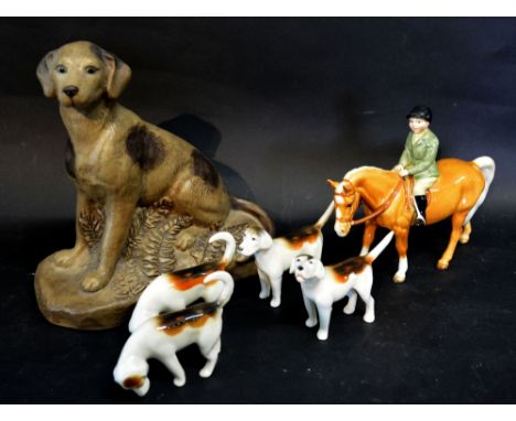 A Beswick Hunting Group with a Horse and Rider and Four Hounds, together with a Poole Pottery matte glazed model of a dog
