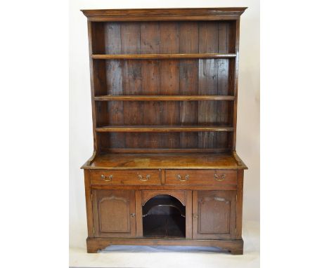 A George III Oak Dresser of Small Proportions, the boarded shelf back above two frieze drawers with central alcove flanked by