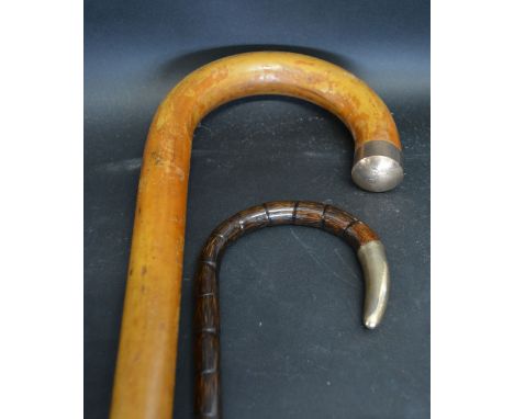 A 9ct. Gold Mounted Walking Stick, together with another similar 9ct. gold mounted cane