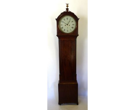 A George III Mahogany Long Case Clock, the moulded arched hood with brass eagle finial above a shaped door flanked by quarter