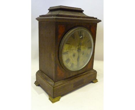 A 19th Century Bracket Clock, the silvered dial with Roman numerals and with three train musical movement raised upon low bra