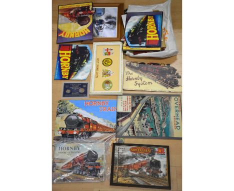 A quantity of reproduction Hornby advertising signs, card and metal; original Hornby book of trains 1937-1938; other framed a