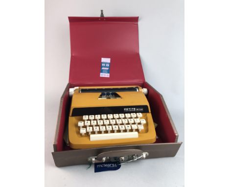 PETITE DELUXE PORTABLE TYPEWRITER, along with a pair of Frank-Nipole binoculars by Charles Frank and three cameras