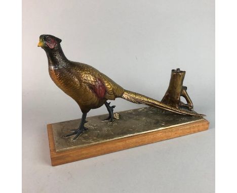 EARLY 20TH CENTURY TABLE MODEL STRIKER MODELLED AS A PHEASANT, in cold-painted spelter, with a wooden base, 32cm long