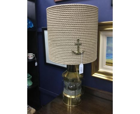 BRASS SHIP'S LAMP, converted as an electric table lamp, the ropework shade with brass anchor motif, 74cm high overall