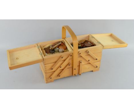 A number of vintage sewing items including pincushions, needle holders and Art Deco belt clasps in a wooden sewing box, 