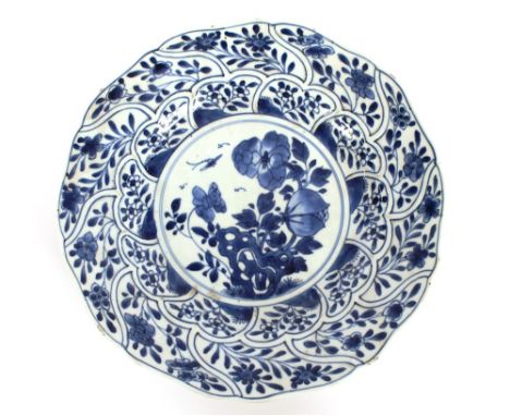 A Chinese blue and white Kanghsi platter, having raised decoration and shaped border, 27.5cm dia.