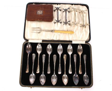 A cased set of 12 plated grapefruit spoons; two pairs of plated knife rests; a silver and ivory handled pickle fork; and a le