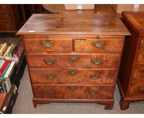 A George III mahogany chest of small proportions, fitted brushing slide, two short and three long graduated drawers below, ra