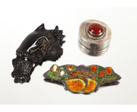 A Liberty enamel and silver brooch; a Victorian hand carved jet brooch and an oval silver patchbox set with a cornelian