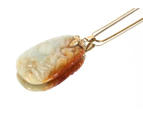 A Chinese jade pendant, carved as a monkey in a tree with 14 carat gold mounts suspended by a 9 carat gold fine link chain