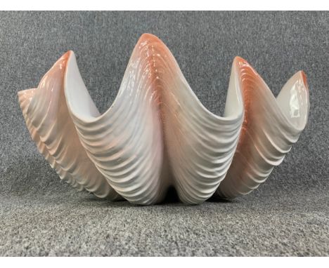 A large ceramic model of a giant clam shell. H.27 W.58 D.42cm 