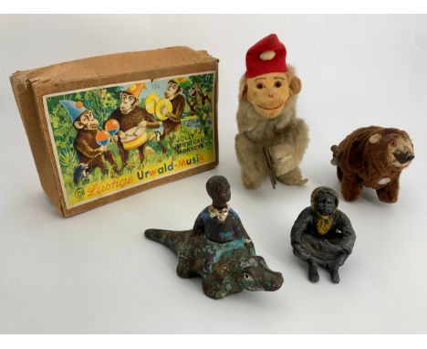 A collection of vintage toys to include a boxed wind-up musical monkey, etc. H.19cm (largest) 