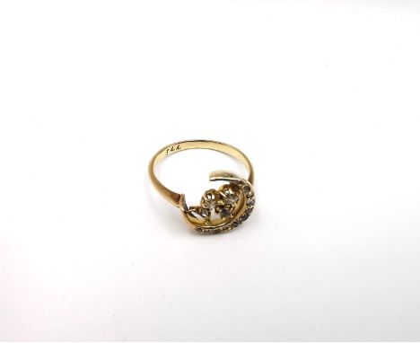 A Victorian yellow metal (tests as 9ct) diamond set crescent and clover ring inset with diamonds and cubic zirconia. Set with