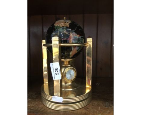 Modern brass revolving globe with clock and barometer dials 