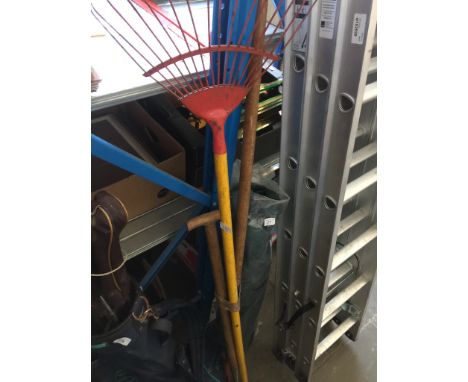 A bundle of garden tools and a golf bag with clubs. 