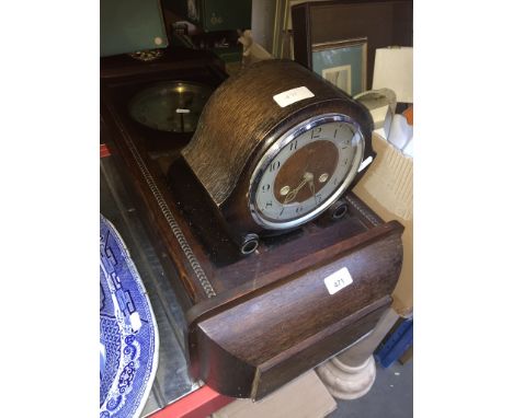 A mantel clock and a wall clock. 