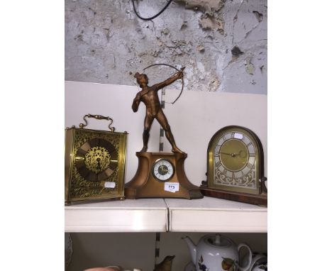 A spelter figural mantle clock and two others. 