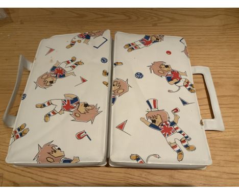 1966 World Cup Willie Seat Cushion: Folded cushion used to pad the wooden Wembley Stadium seats at the World Cup. Intended to