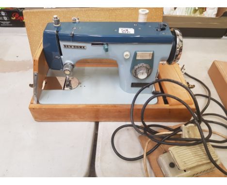 Vintage 'new home' cased electric sewing machine with instructions together with Toyota RS2000 Series Electric Sewing Machine