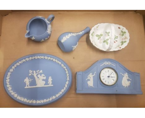 A collection of Wedgwood blue jasper ware items to include a mantel clock, oval plaque, small jug and a bud vase, together wi