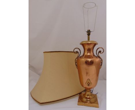 A copper table lamp in the form of a samovar with pierced scroll side handles on raised square base to include shade, 97cm (h