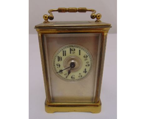 A brass carriage clock with white enamel dial and Arabic numerals, 10.5 x 7.5 x 6cm