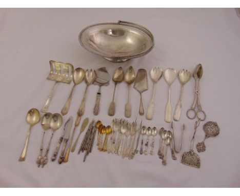 A quantity of silver plate to include a roll basket and flatware