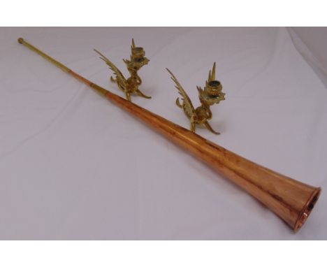 A late Victorian brass and copper telescopic post horn and a pair of brass candlesticks in the form of Griffins (3)