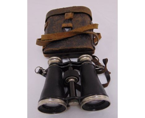 A pair of early 20th century binoculars with integral compass in fitted leather case
