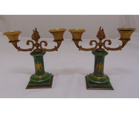 A pair of late 19th century French two light candelabra, the porcelain columns with gilt decoration supporting ormolu branche