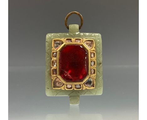 A diamond, jade and foil backed ruby red coloured tablet pendant, the central octagonal red panel, surrounded by fourteen rou