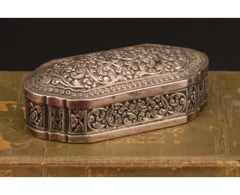 An Indian silver shaped rectangular table snuff or tobacco box, profusely chased with lotus and scrolling leaves, 11cm wide, 