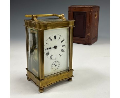 An early 20th century carriage clock, brass serpentine case, white dial, bell striking movement signed JUST, 15.5cm high, wit