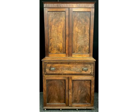 A George III mahogany secretaire bookcase, outswept cornice to top above a pair of well-figured mahogany panelled doors. The 