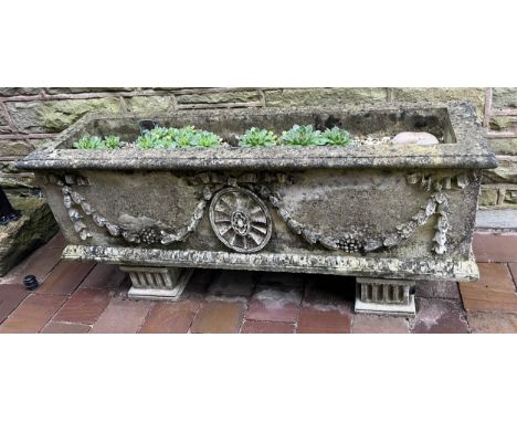 A rectangular Haddonstone type garden trough, cast with Neo-Classical roundels, swags and festoons, fluted feet, 122cm wide, 