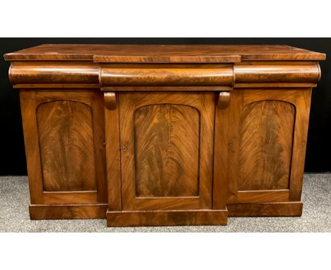 An early Victorian mahogany chiffonier sideboard, break-centre front, with three frieze drawers, above three cupboards, stepp