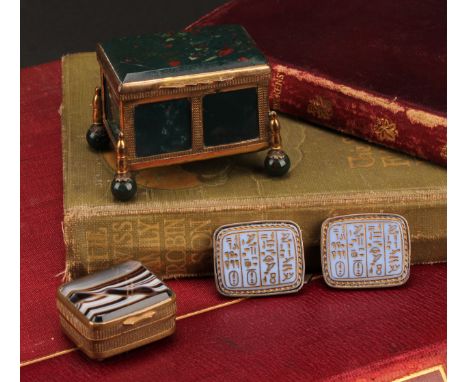 An early 20th century gilt metal mounted agate casket, engine turned borders, ball feet, 6cm wide; another box; a pair of Egy