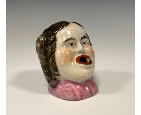 An early 19th century English pottery novelty inkwell and pen rest as a ladies head, 6cm high, c.1820&nbsp;