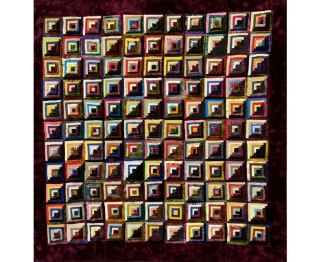 A 20th century log cabin quilt, with vibrant coloured square blocks, sunshine and shadow shading, tones include Yellow, Green