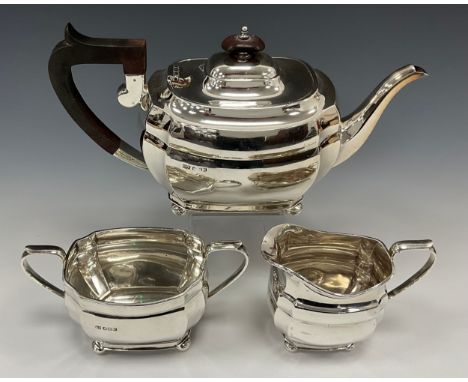 A George V silver three-piece tea set, teapot with ebony handle, twin handled sugar bowl and milk jug, G&amp;C, Sheffield 194