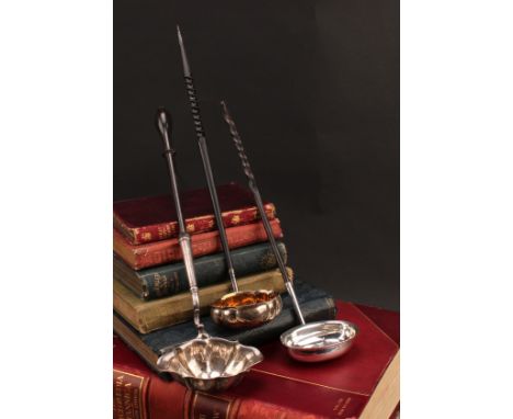 A George III silver toddy ladle, fluted oval bowl, turned fruitwood haft, 34cm long, London 1777; others (3)