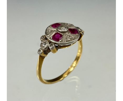 A Ruby and diamond cluster ring, circular crest set with raised central round brilliant cut diamonds, surrounded by alternati