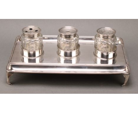 A large George III silver rounded rectangular partners' inkstand, quite plain, glass wells and sander, reeded border, bracket