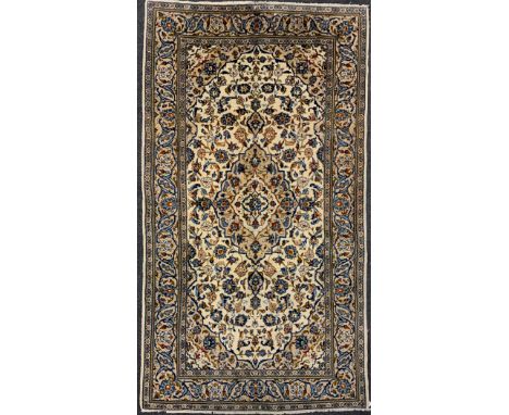 A Central Persian Kashan carpet, central Navette-shaped medallion within a field of stylised scrolling floral stems, in tones