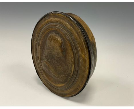 An early 18th century pressed horn oval snuff box, attributed to Jean Obrisset, the push-fitting cover in relief with a bust-
