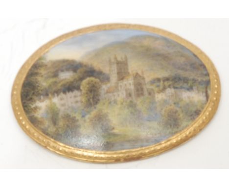 A Royal Worcester porcelain brooch plaque or panel, the domed upper hand-painted with a Gothic Revival church in situ, gilt b