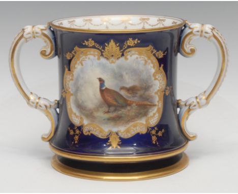 A Royal Worcester two handled loving cup, painted by Jas. Stinton, signed, with a brace of pheasants, within a raised gilt sc